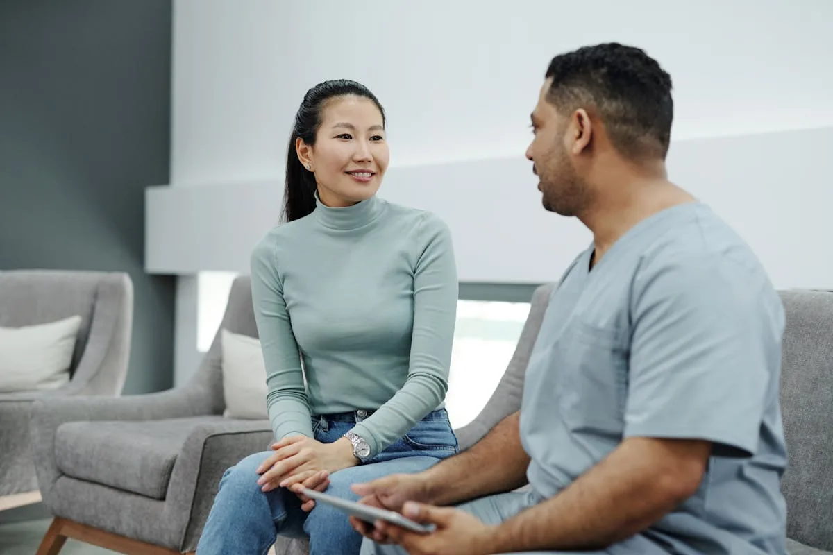 Doctor talking to female patient — women's health consultation