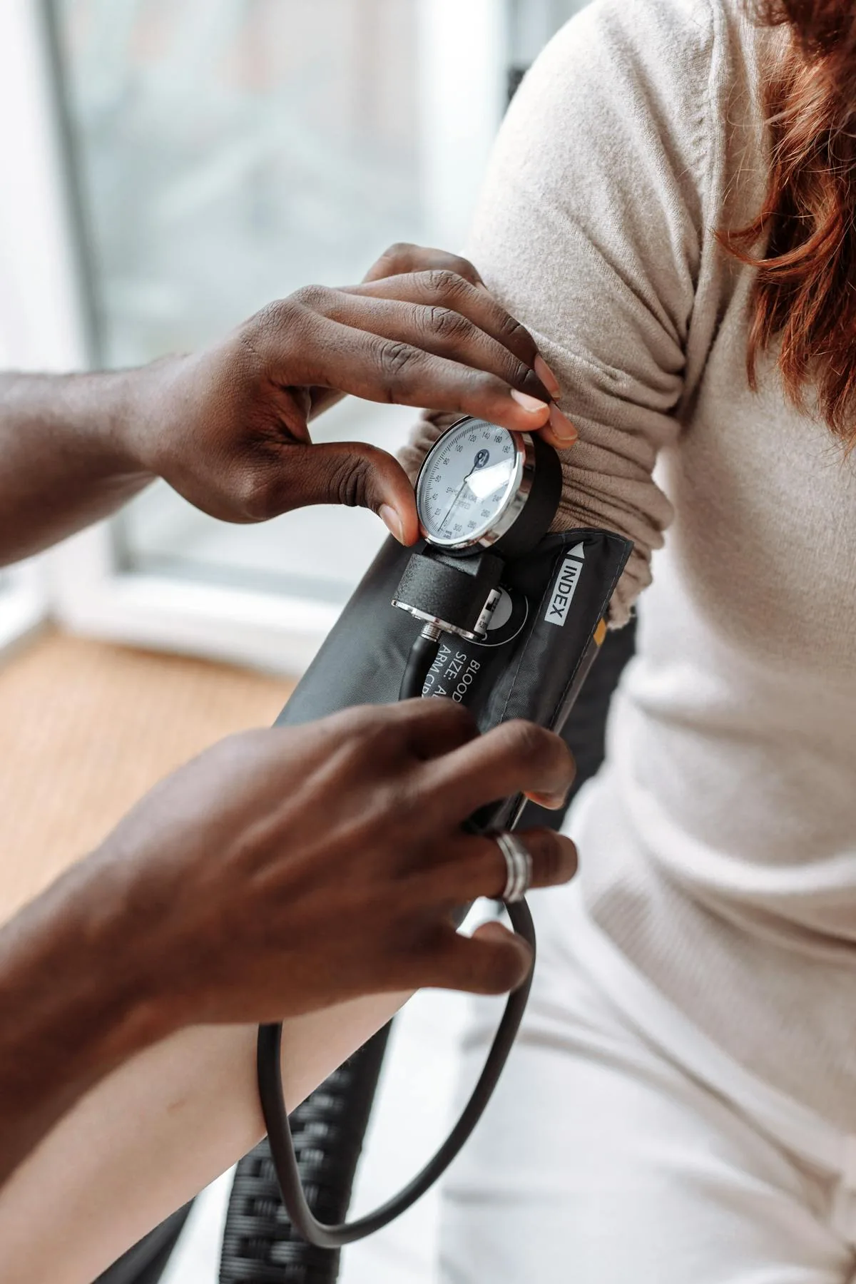 Healthcare provider measuring blood pressure with arm cuff