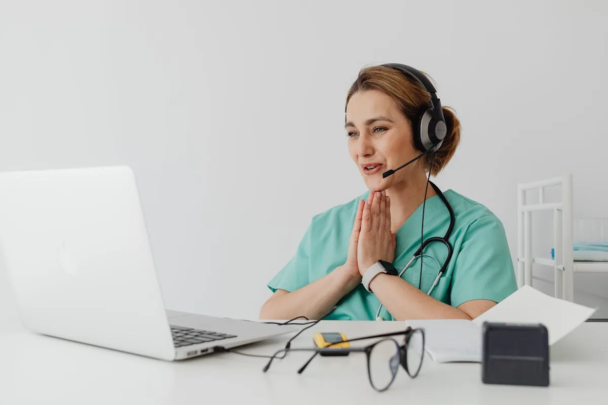 Doctor conducting telehealth video consultation on laptop