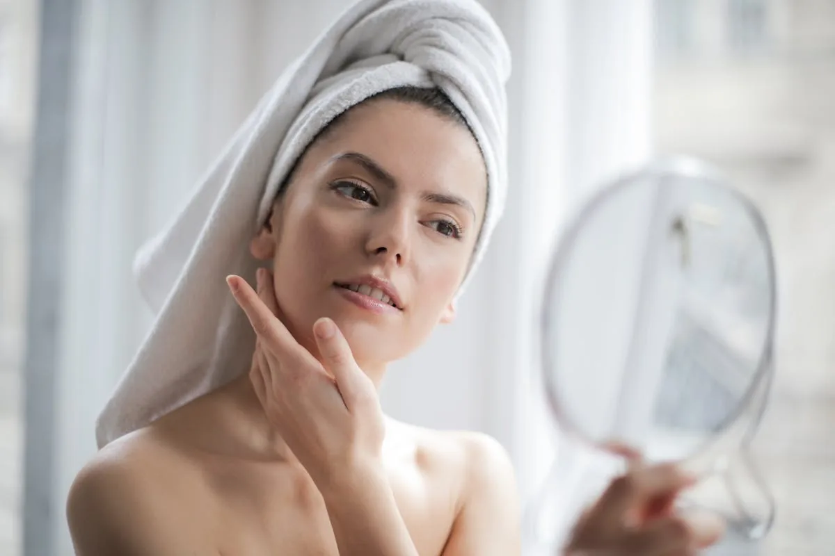 Woman touching face — facial redness evaluation