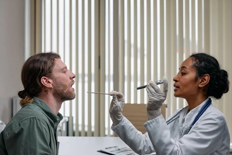 Doctor examining patient throat — strep throat evaluation