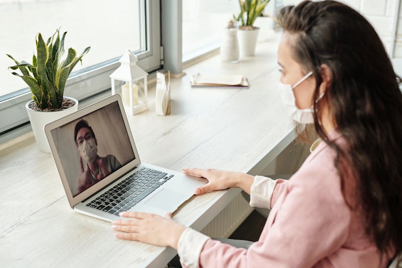 Woman on telehealth video call with provider
