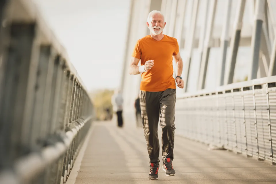 An active older adult jogging outdoors, keeping the heart healthy