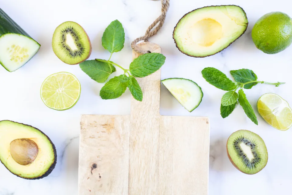 Fresh avocado and other heart-healthy foods on a marble surface