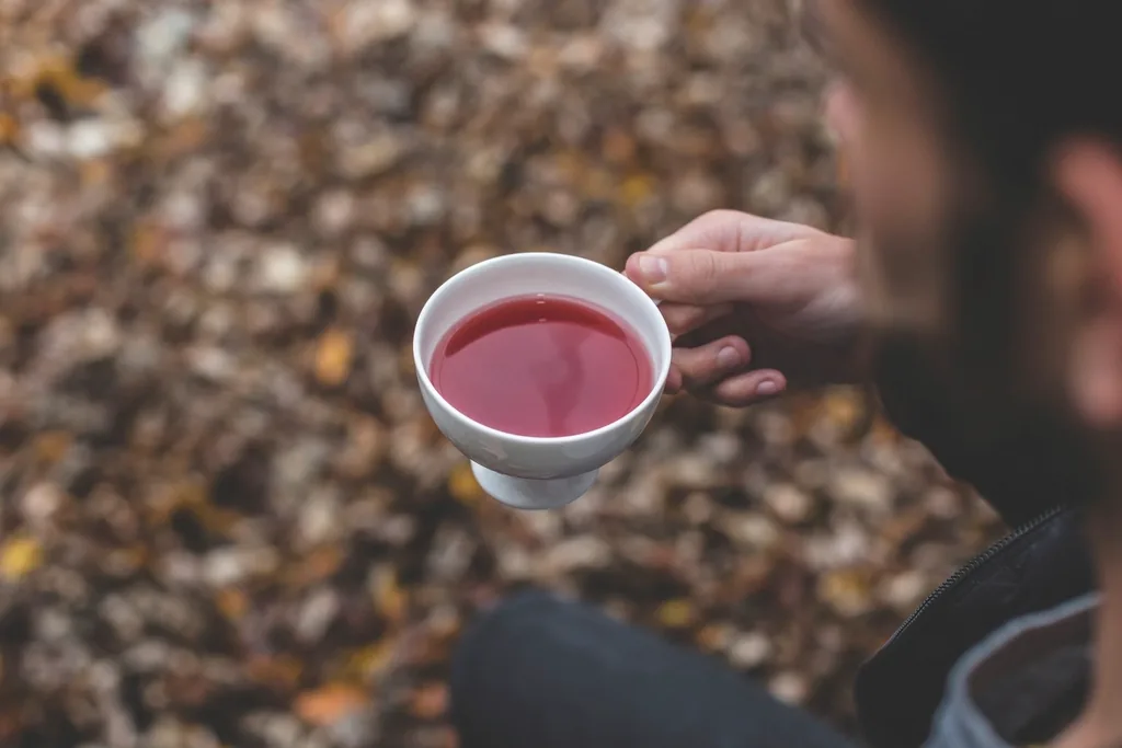 A warm cup of herbal tea held in hand