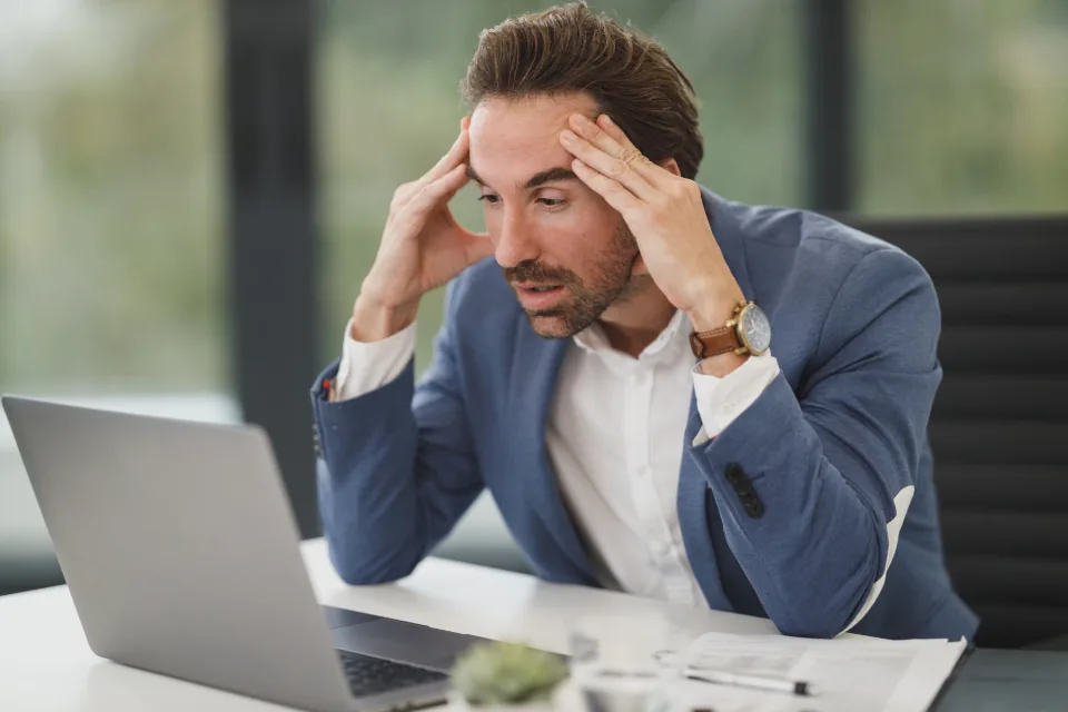 Person holding their head with hands at the temples during a headache
