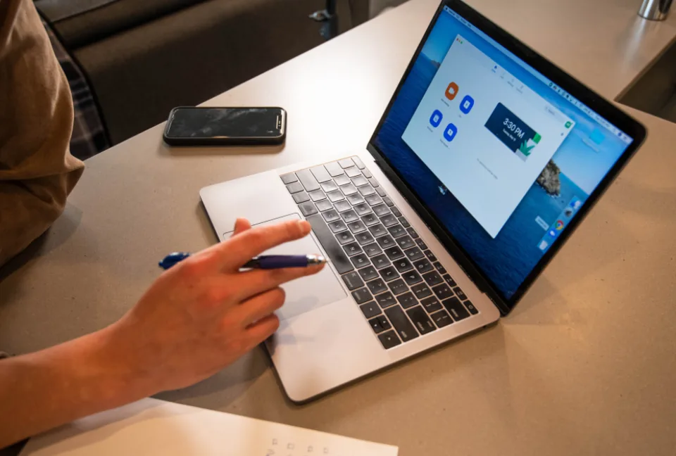 Person comparing telehealth options on a laptop at a desk
