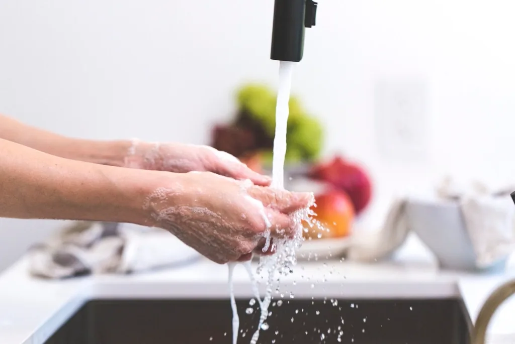 Washing hands under running water, a key way to prevent the spread of staph and MRSA infections