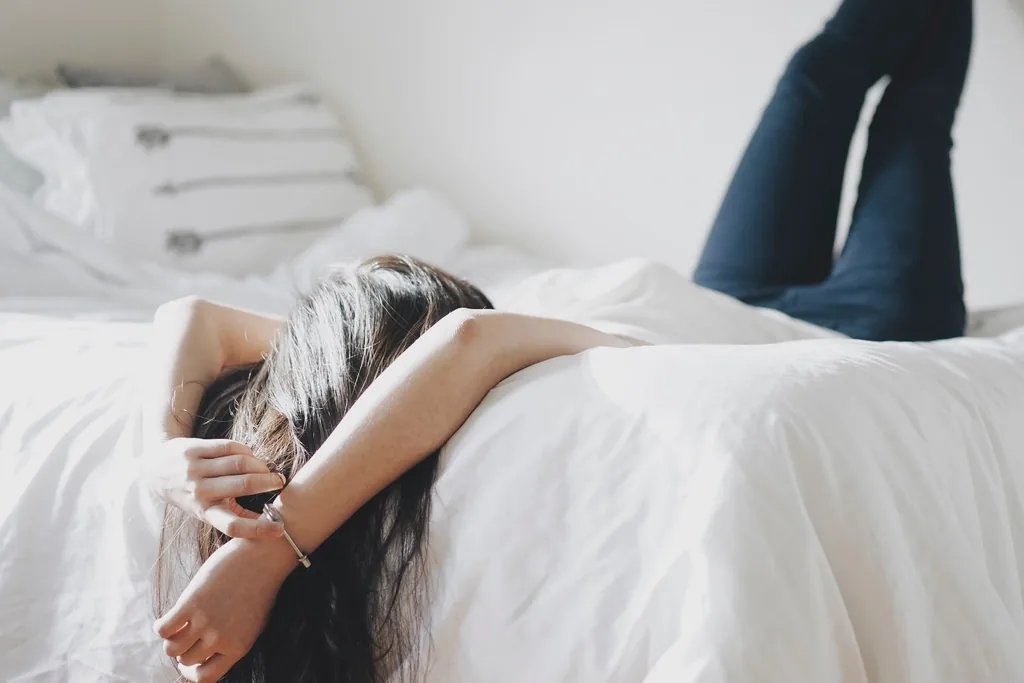 Woman lying down resting during a migraine attack