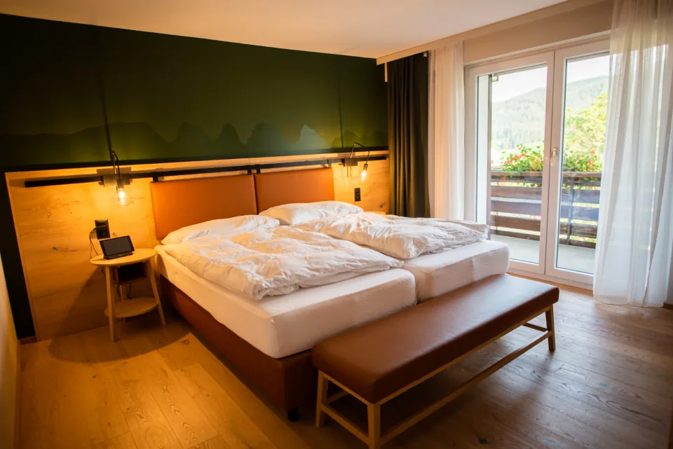 Bed with white linens and mattress where bed bugs commonly hide