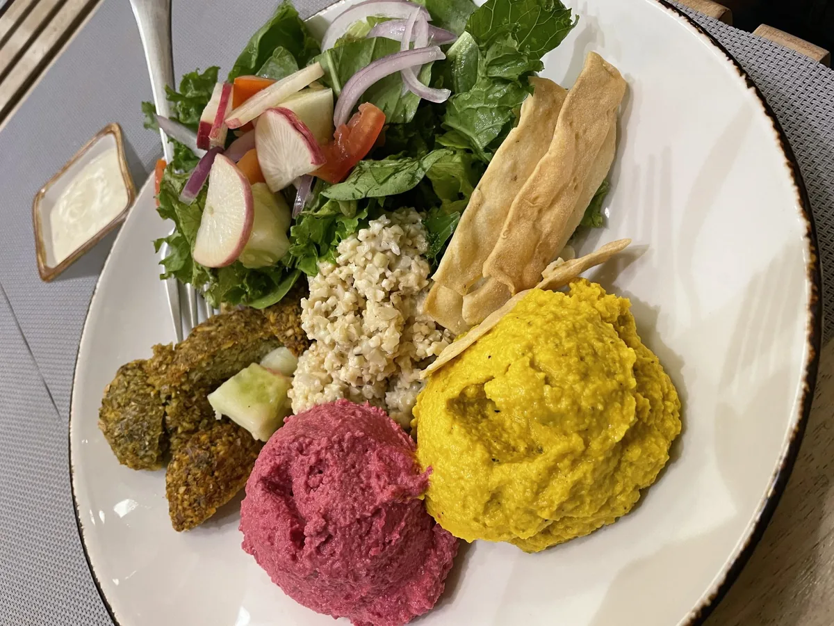 A plate of food on a table, representing meals that can trigger stomach pain after eating