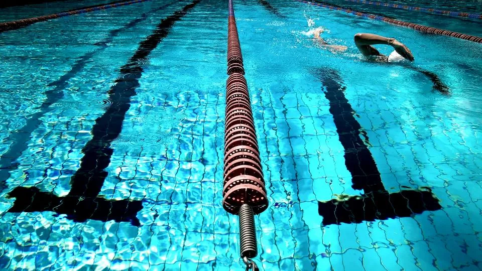 Swimmer doing laps in a pool, a common cause of swimmer's ear
