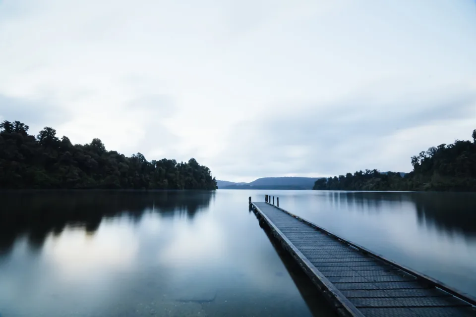 Calm, still lake at dusk evoking a sense of peace for anxiety care