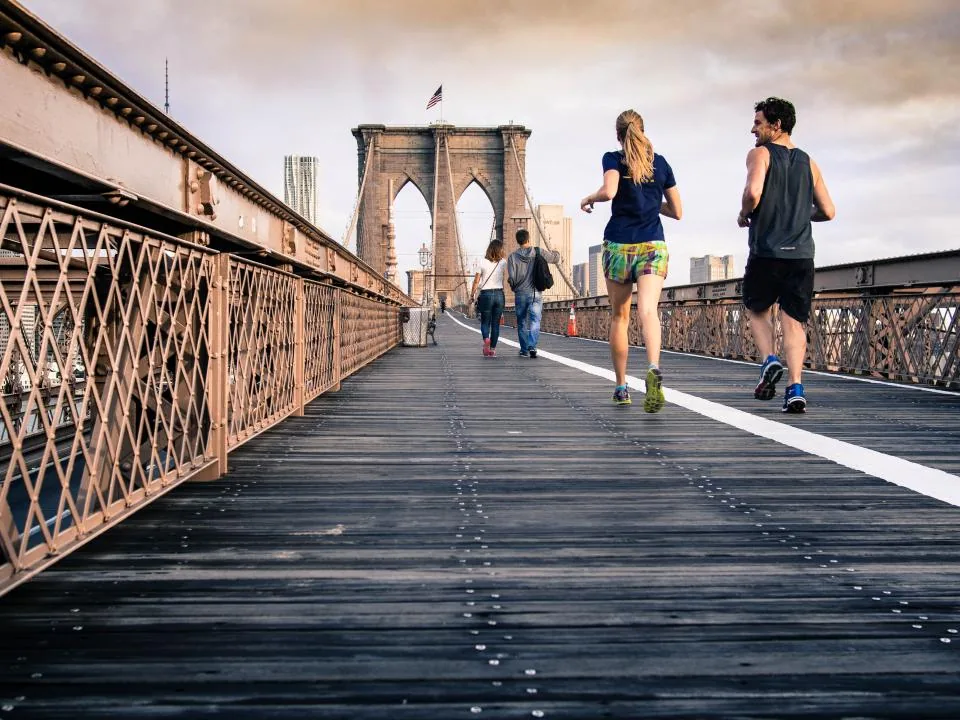 People jogging across a bridge, exercise that supports healthy blood pressure