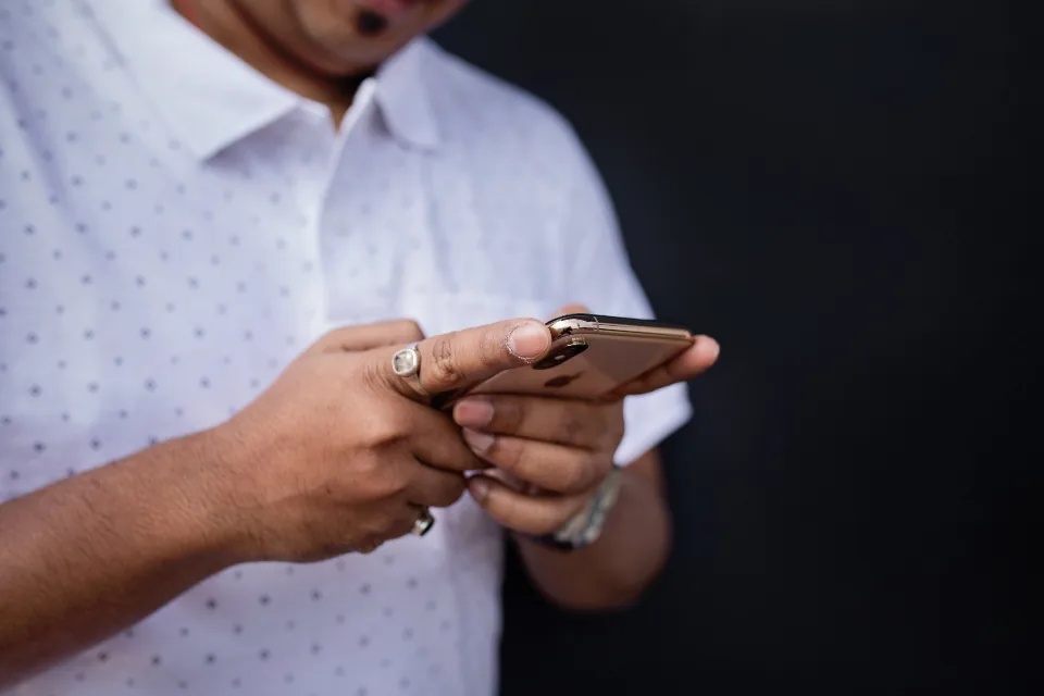 A person using a smartphone to access online urgent care from home