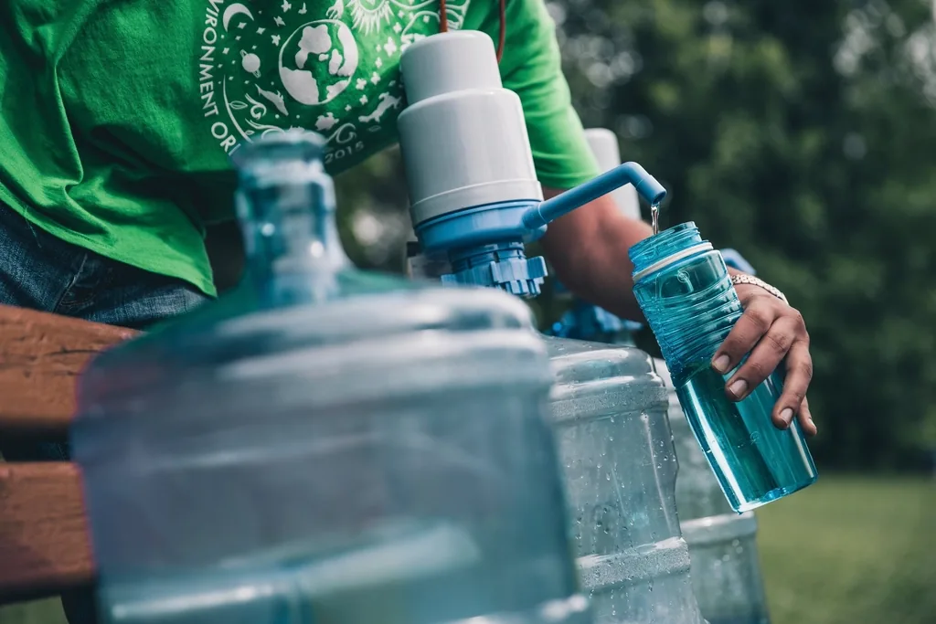 Filling a reusable water bottle, a reminder to stay hydrated to help prevent urinary tract infections